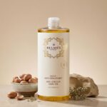 Flacon huile anti-vergetures Belmés Profissional – noix d'argan dans bol pierre naturelle et plantes aromatiques en arrière-plan tous types de peau