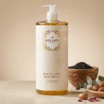 Flacon huile de nigelle Belmés Profissional – bol en bois avec graines de nigelle noires noix d'argan et feuilles d'eucalyptus en arrière-plan