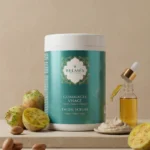 Flacon transparent huile anti-vergetures Belmés Profissional au design oriental crème et doré, entouré de noix d'argan dans un bol en grès, pierre naturelle et plantes aromatiques séchées. Soin corps préventif et réparateur naturel pour tous types de peau, idéal pendant la grossesse et en post-partum, recommandé pour spas, instituts de beauté et hôtels au Maroc et en France.