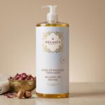 Flacon huile de massage tonifiante Belmés Profissional – bol doré marocain avec pétales de rose séchés et noix d'argan en arrière-plan